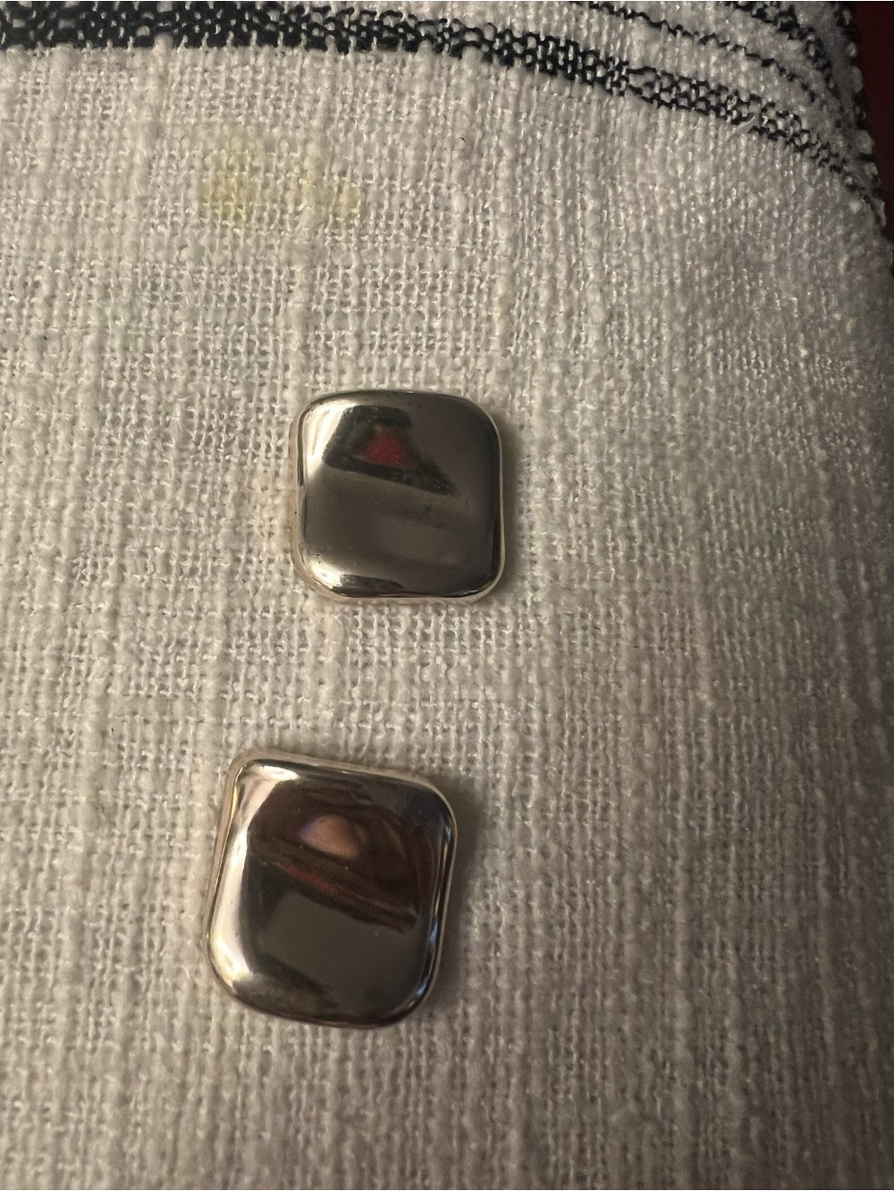 Silver Square Button Accent on Textured White Fabric